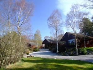 una casa con entrada frente a un patio en Tullochwood Lodges, en Forres