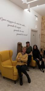 a group of people sitting on a couch in a room at B&B iMori in Caltagirone