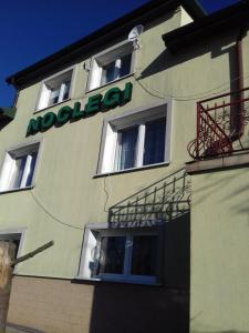 a building with a sign on the side of it at Homestay Stróżówka in Gorlice