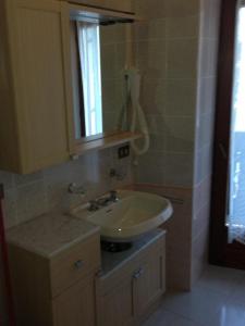 a bathroom with a sink and a mirror at Villa dei Fiori in Cavedago