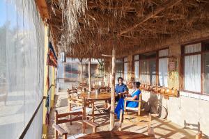 two people sitting at a table in a restaurant at Talist Siwa in Siwa