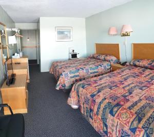 En eller flere senge i et værelse på Chimo Motel