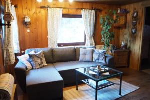 a living room with a couch and a table at Ferienhütte in Ruhpolding in Ruhpolding
