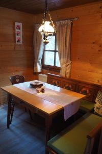 a dining room with a wooden table and a window at Ferienhütte in Ruhpolding in Ruhpolding