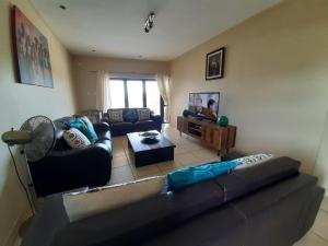 a living room with a couch and a table at Whale Rock in Margate