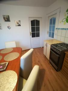 a kitchen with a table and a stove top oven at JULIUSZ in Lądek-Zdrój