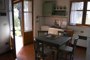 a kitchen with a table and some chairs and a sink at Villa Il Cerro in Radicofani
