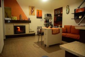 a living room with a fireplace and a couch at B&B Annalu' in Guspini