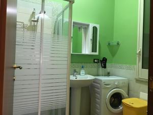 a bathroom with a sink and a washing machine at Villafiorita in Gioiosa Marea