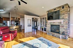 a living room with a fireplace with a flat screen tv at Grand Cabin with Hot Tub and Views - 3 Miles to Hiking in Terrebonne