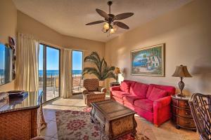 a living room with a red couch and a view of the ocean at Gulf Coast Luxury Getaway on Orange Beach with Views in Orange Beach