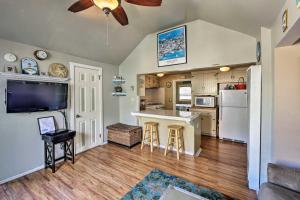 a kitchen and living room with a ceiling fan at Tropical Island Escape with Deck, Walk to Avalon Bay in Avalon