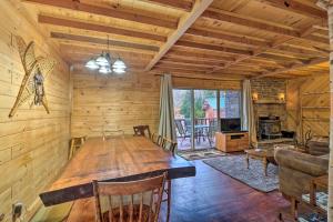 a dining room with a large wooden table in a cabin at Secluded Johnsburg Outdoor Oasis - Private Hot Tub in Johnsburg