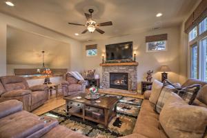 a living room with couches and a fireplace at Sugar Bear Lodge with Game Room - 5 Mi to Village! in Lake Arrowhead