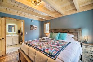 a bedroom with a large bed with a wooden headboard at Newly Built Cabin with Hot Tub - 16 Mi to Stowe Mtn! in Morristown