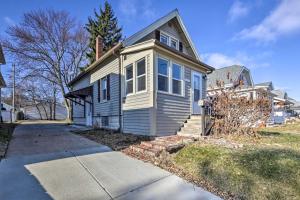a small white house on a street at The Cozzy House 4-Minute Drive to Miller Park! in West Allis