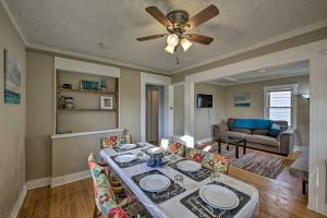 a living room with a table and a ceiling fan at The Cozzy House 4-Minute Drive to Miller Park! in West Allis