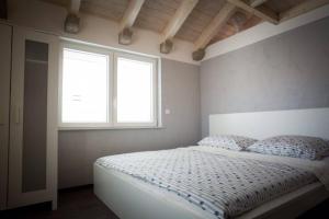 una camera con un letto bianco e una finestra di Relax Comfy Cozy Apartment a Cavtat