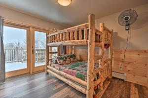 a bedroom with a bunk bed and a balcony at Rustic 3-Story Pittsburg Cabin with Lake and Mtn Views in Pittsburg
