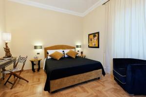 a bedroom with a bed and a desk and a piano at Casa Roma Luxury Apartment in Rome