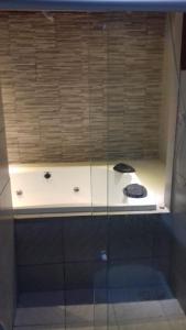 a glass cabinet with two black objects on top of it at GRAVATÁ-PE- CASA 4 QUARTOS in Gravata
