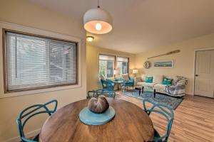 a living room with a wooden table and chairs at Cute Cottage with Deck Walk 115 Ft to Brewery and Cafe in Poulsbo