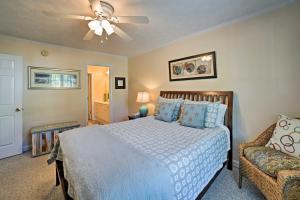 a bedroom with a bed and a ceiling fan at Oak Island Cottage - Walk to Beach and Intracoastal! in Oak Island