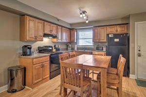 een keuken met houten kasten en een tafel en stoelen bij Ocean City Escape Less Than 1 Mile to Beaches and Boardwalk! in Ocean City