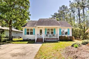 a white and blue house with a porch at Oak Island Cottage - Walk to Beach and Intracoastal! in Oak Island