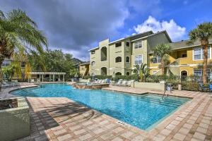 a swimming pool in front of a building at Modern Condo with Pool 4 Mi to Clearwater Beach! in Clearwater