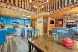 a kitchen and dining room with a table in a cabin at Furnished Deck Cabin in Coconino National Forest in Munds Park