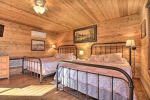 a bedroom with two beds in a cabin at Carters Hideaway by Fairy Stone Pool and Hot Tub in Henry +30 photos