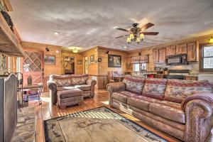 a living room with a couch and a ceiling fan at Carters Hideaway by Fairy Stone Pool and Hot Tub in Henry