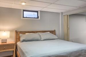 a bedroom with a bed and a window at Mid-Century Gem Dog-Friendly Home Near DC! in Rockville