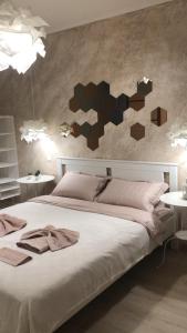 a bedroom with a large bed with two tables at City centre apartment in Kolomyya