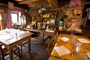 a restaurant with tables and a teddy bear on the wall at Agriturismo Al Marnich in Schignano