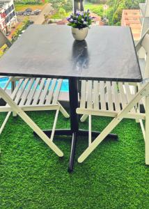 a table with a bench and a table with a potted plant at Cheqma D'perdana Apartment Kota Bharu in Kota Bharu