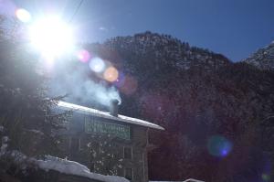 a sign on a building with snow on it at Rifugio Casa Lobietti in Mollia