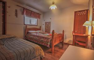 a bedroom with two beds and a table and a lamp at Vieille Maison Rustique Espace Intéressant in Quebec City