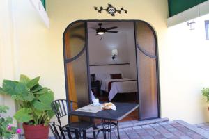 a mirror on a patio with a table and chairs at Hotel Antigua Posada in Cuernavaca