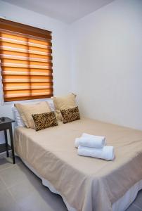 Postel nebo postele na pokoji v ubytování Medano Beach Villas + 37 fotografií