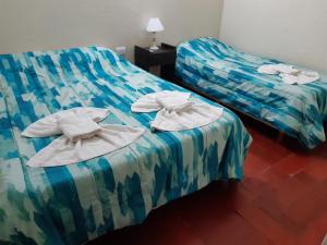 Una cama o camas en una habitación de Hotel Santa Elena