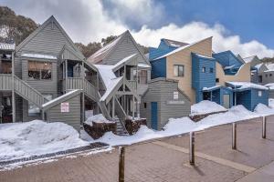 a row of houses with snow on the ground at Snowgums 13 in Dinner Plain