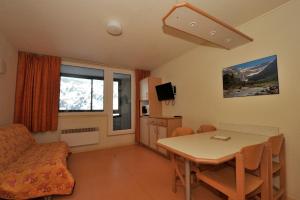 a small living room with a table and a chair at Résidence Azureva La Mongie in La Mongie