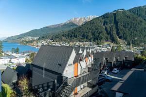 a row of houses with mountains in the background at Heartland Hotel Queenstown in Queenstown