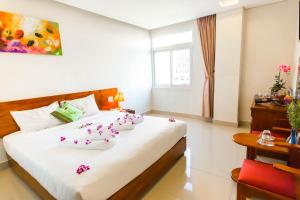 a bedroom with a large bed with flowers on it at Kiên Cường 2 Hotel in Da Nang +197 photos