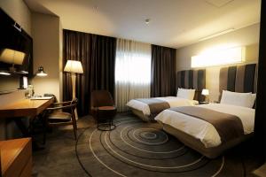 Postel nebo postele na pokoji v ubytování Best Louis Hamilton Hotel Haeundae