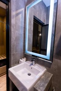 a bathroom with a white sink and a mirror at Brown Hotel in George Town +14 photos
