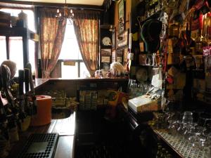 a room with a bar with a window at Buggle's Pub and Accommodation in Kilrush
