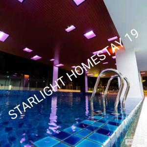 a swimming pool with a sign that reads sanctuary homes at Star Light Homestay 19@ The Venus in Sitiawan